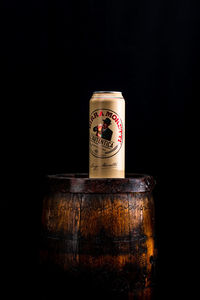 Close-up of beer glass against black background