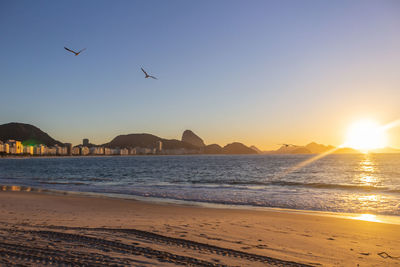 Scenic view of beach against sky during sunset