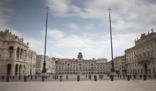 Buildings in city against cloudy sky