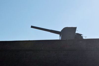 Low angle view of traditional windmill against clear sky
