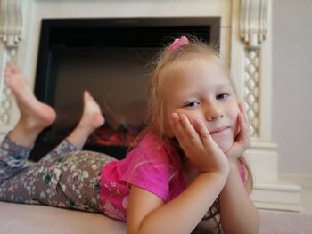 Portrait of cute girl sitting at home