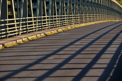 Shadow of railing on footpath