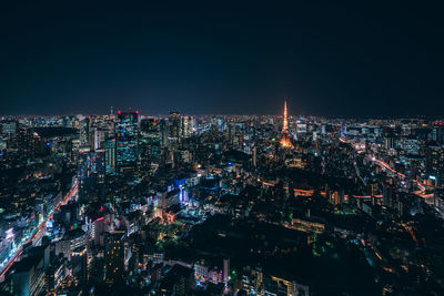 High angle view of illuminated buildings against sky at night