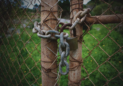 Close-up of padlock on chainlink fence