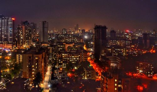 High angle view of illuminated city buildings at night