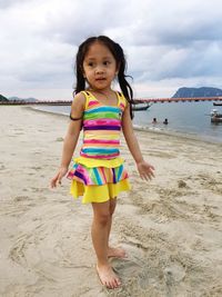 Portrait of cute girl standing on beach