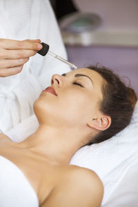 Midsection of woman lying on sofa