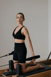 Portrait of young woman exercising in gym