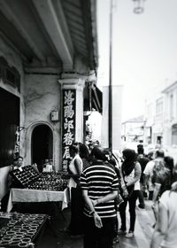 Rear view of man walking in front of building