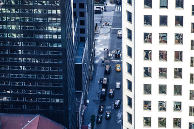 High angle view of traffic on road amidst buildings in city