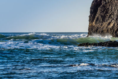 Waves roll in at cannon beach in oregon state.