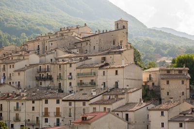 Buildings against mountain in city