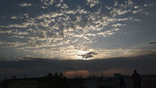 Silhouette of birds against sky during sunset