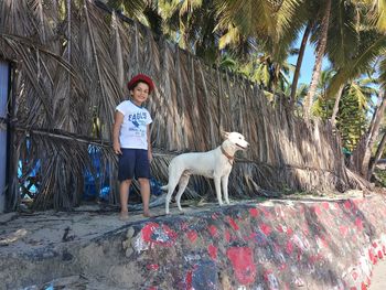 Portrait of man with dog standing outdoors