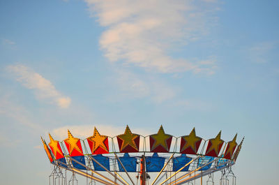 Low angle view of amusement park ride against sky