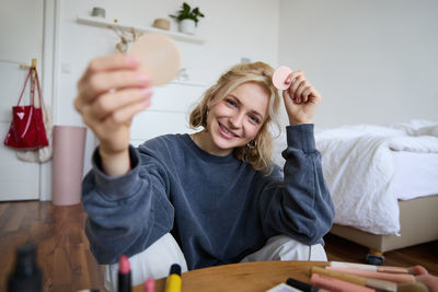 Portrait of young woman painting