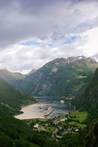 Scenic view of lake and mountains against sky