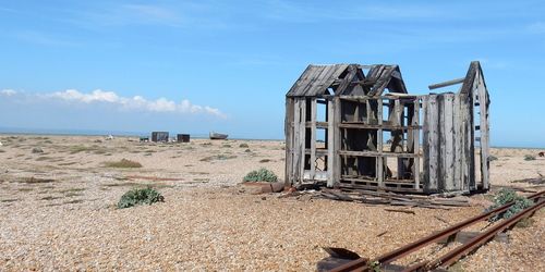 Built structure on beach against sky