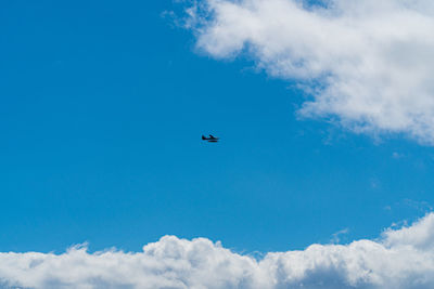 Low angle view of airplane flying in sky