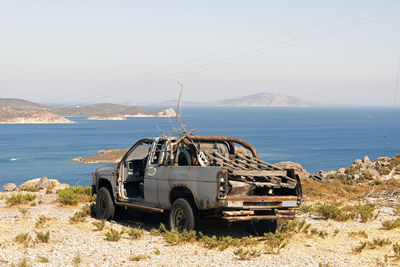 Wrecked and abandoned cars and ships in a remote location in the island