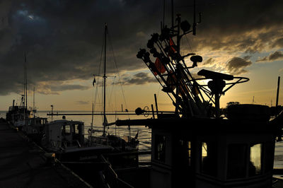 Sailboats in harbor at sunset