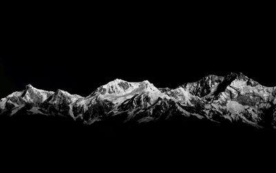 Scenic view of snow mountains against clear sky at night