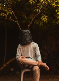 Rear view of man sitting outdoors