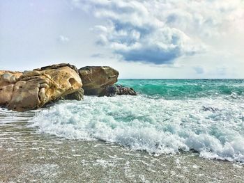 Scenic view of sea against cloudy sky