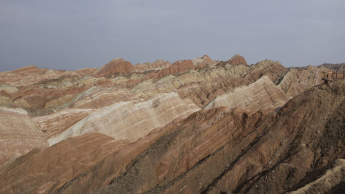 Scenic view of colorful mountain against cloudy sky - danxia landform in northwest china