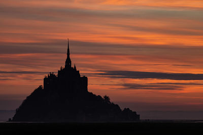 Silhouette building against sky during sunset