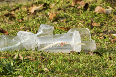Close-up of bottle on grass in field