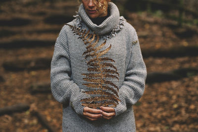 Portrait of woman standing in forest