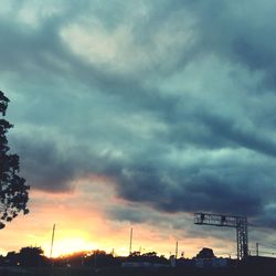 Low angle view of silhouette trees against sky