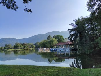 Scenic view of lake by building against sky