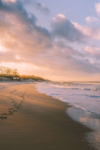 Scenic view of beach against sky during sunset