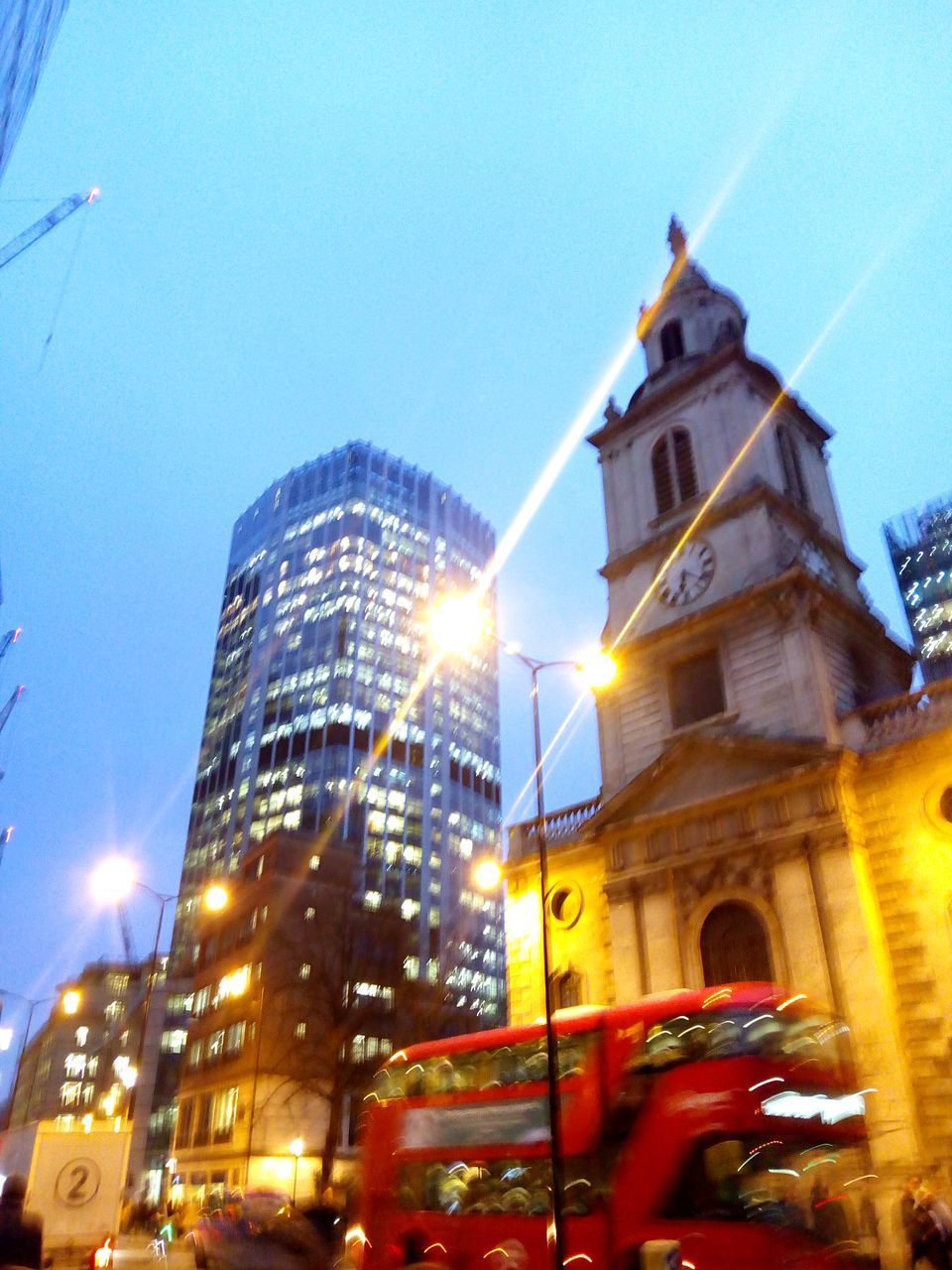 LOW ANGLE VIEW OF ILLUMINATED BUILDING AGAINST SKY