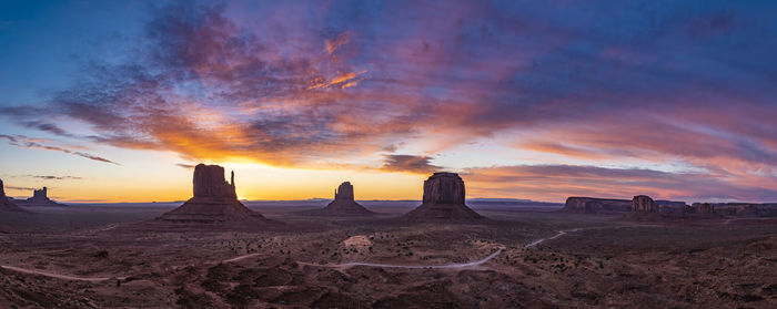 Panoramic view of rock formations against sky during sunset