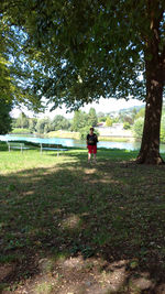 Rear view of woman walking on field