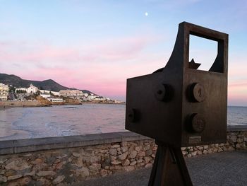 Close-up of rusty metallic structure against sea