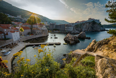 Scenic view of sea and buildings against sky