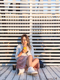 Young woman sitting on hardwood floor