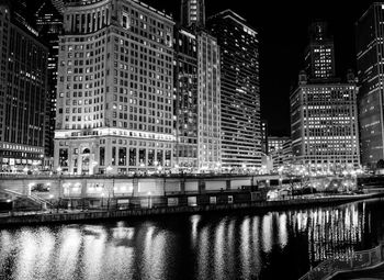 Reflection of illuminated buildings in city at night