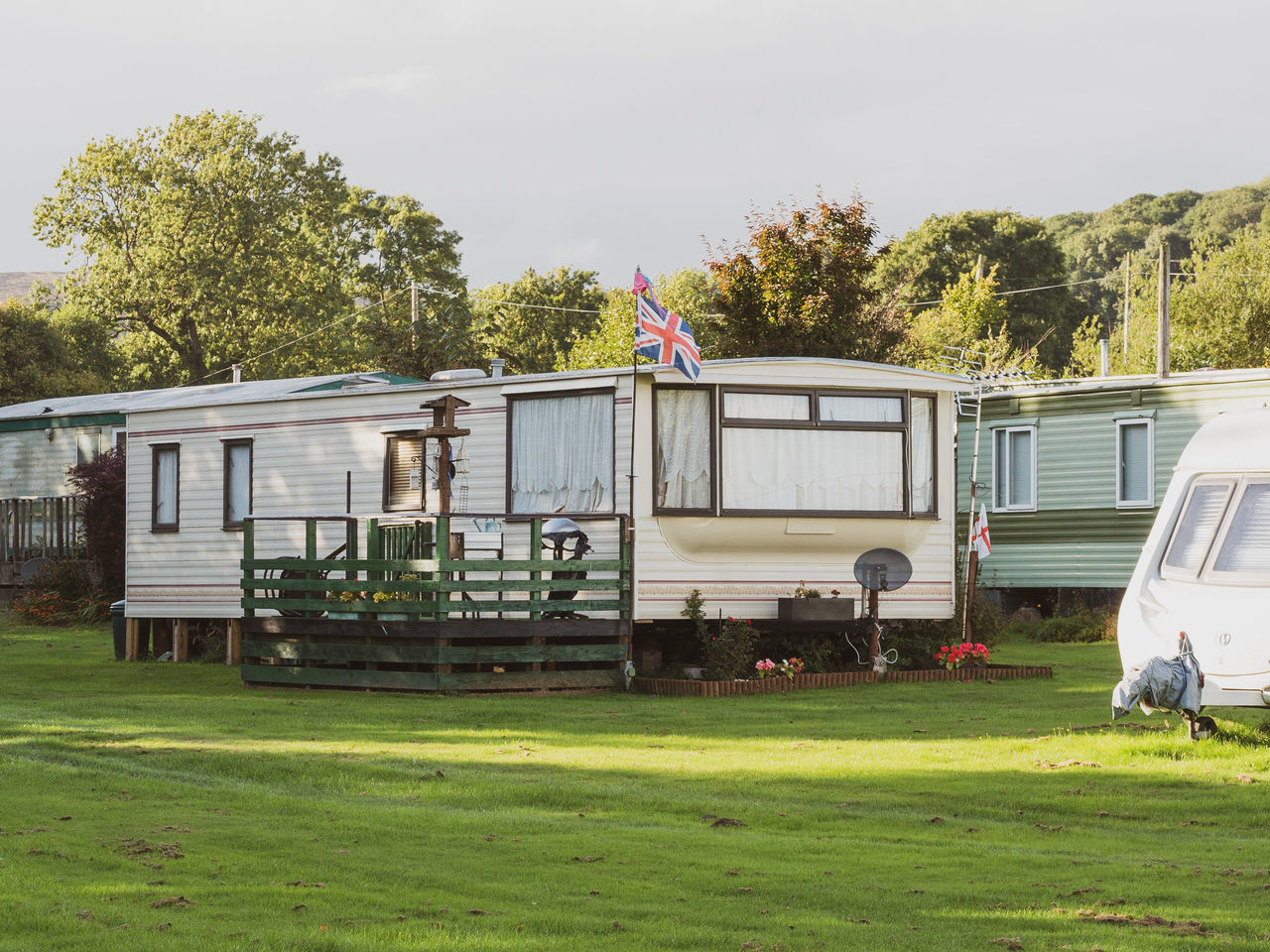 plant, mode of transportation, grass, transportation, vehicle, nature, transport, land vehicle, travel trailer, tree, sky, day, rv, green, outdoors, no people, travel, architecture, motor home