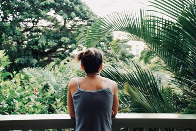 Rear view of woman looking at trees