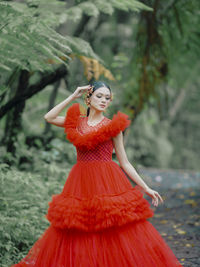 Portrait of young woman standing in forest