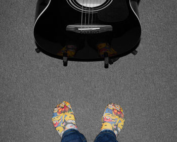 Low section of woman standing on tiled floor