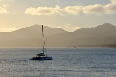 Sailboat sailing on sea against sky