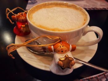 High angle view of coffee cup and decorations on table