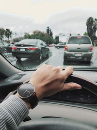 Midsection of person using mobile phone on road