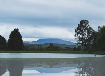 Scenic view of lake and mountains against sky